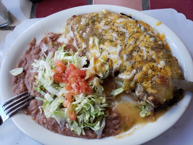 Carne asada smothered in cheese and green chili