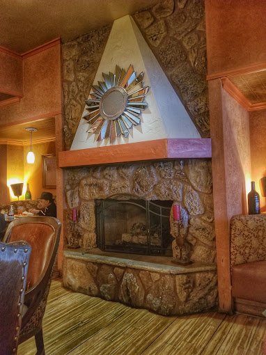 Stone fireplace in Licano's dining room
