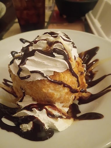 Deep-fried ice cream with chocolate drizzle